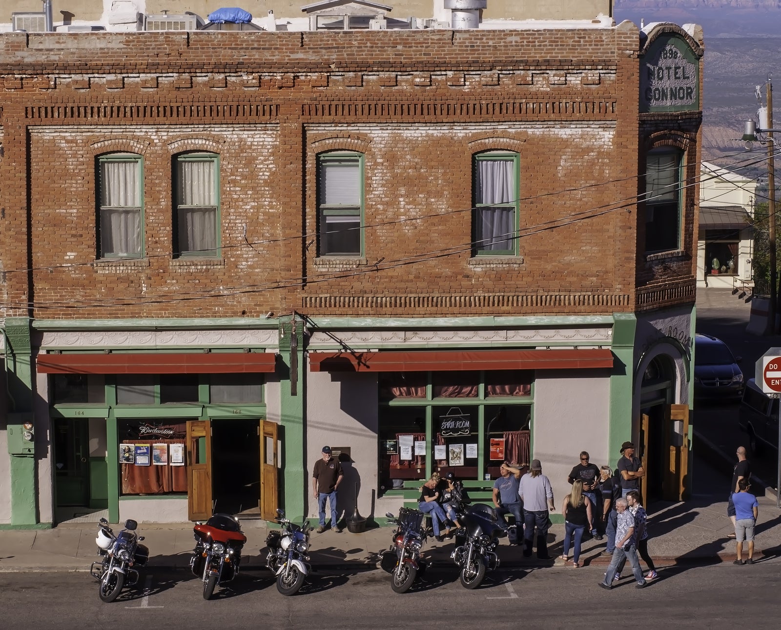   Save Download Preview Jerome, Arizona, USA 04/21/2019 People standing outside of the Conner Hotel next to parked motorcycles on the street on a sunny spring day