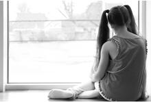 Child sitting at a window