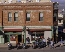   Save Download Preview Jerome, Arizona, USA 04/21/2019 People standing outside of the Conner Hotel next to parked motorcycles on the street on a sunny spring day