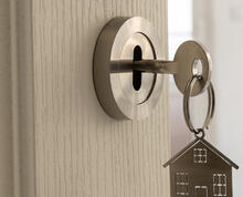 Key with house keychain in a lock